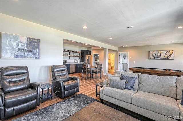 living room with hardwood / wood-style flooring and pool table