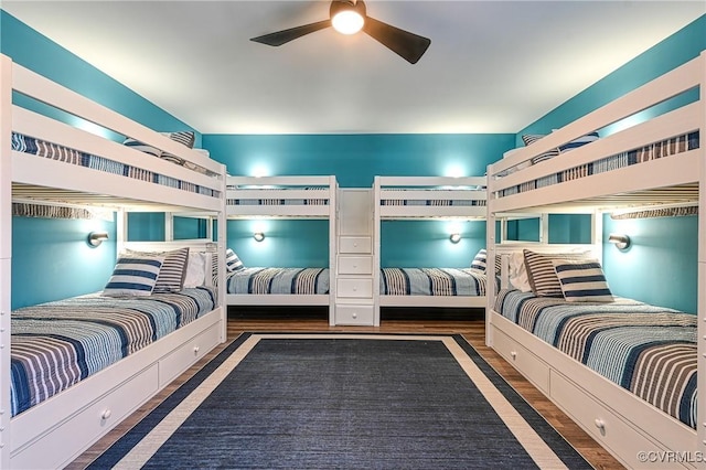 bedroom with dark hardwood / wood-style flooring and ceiling fan