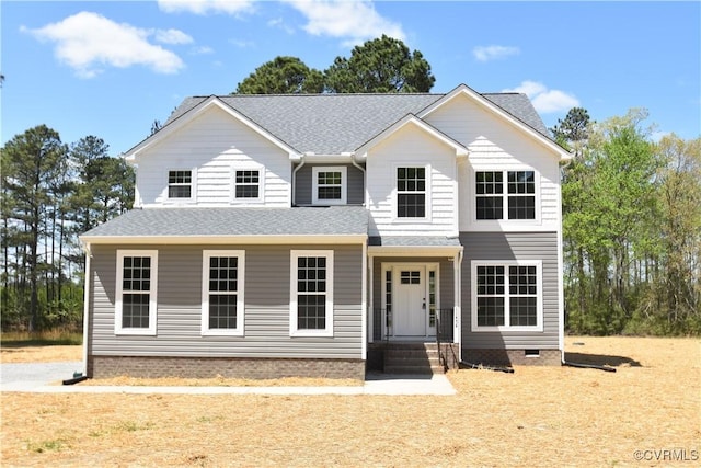 view of front facade featuring roof with shingles and crawl space