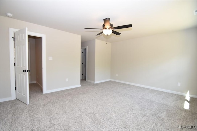 unfurnished room featuring baseboards, ceiling fan, and light colored carpet