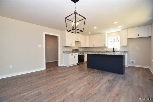 kitchen featuring baseboards, recessed lighting, stainless steel range with electric stovetop, and white cabinets