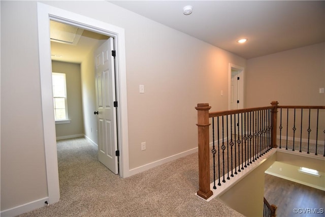 hall featuring carpet floors, recessed lighting, an upstairs landing, and baseboards