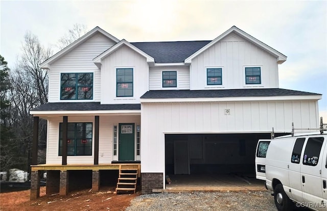 modern farmhouse style home with a porch, a garage, a shingled roof, driveway, and board and batten siding