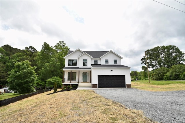 16159 W Patrick Henry Rd, Montpelier, VA 23192 - modern inspired farmhouse featuring a porch, gravel driveway, a front yard, and a garage