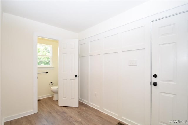 16159 W Patrick Henry Rd, Montpelier, VA 23192 - unfurnished bedroom with light wood-style floors, a closet, baseboards, and ensuite bath