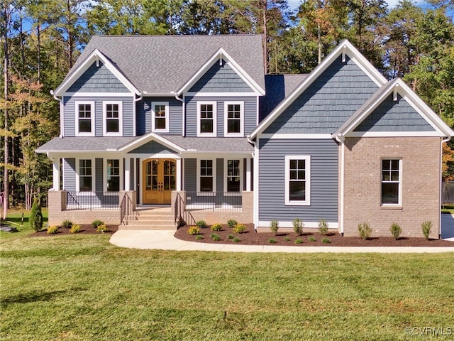 craftsman-style home featuring covered porch and a front lawn