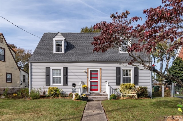 cape cod-style house featuring a front yard