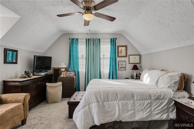 carpeted bedroom featuring a textured ceiling, ceiling fan, and lofted ceiling