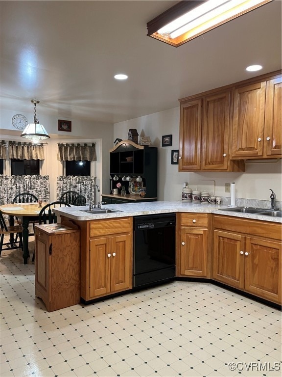 kitchen featuring hanging light fixtures, sink, kitchen peninsula, and black dishwasher