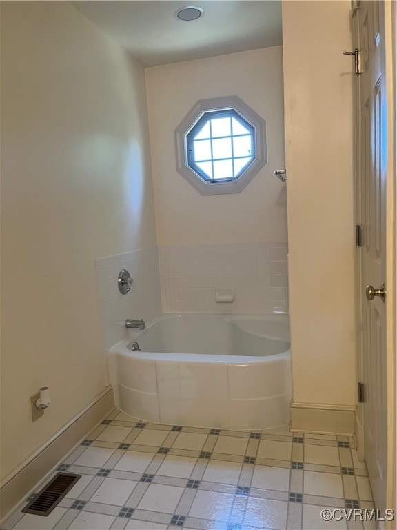 bathroom featuring a washtub