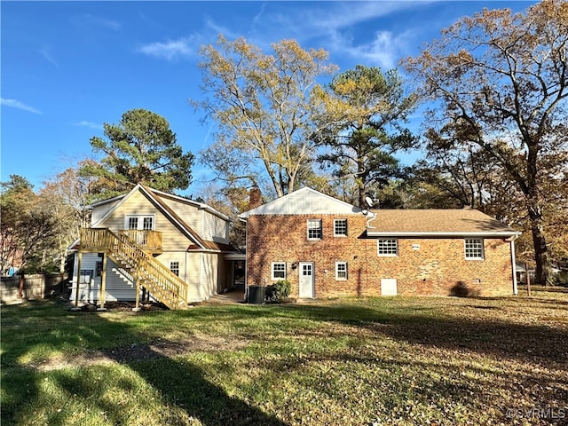 back of property featuring a lawn and central AC