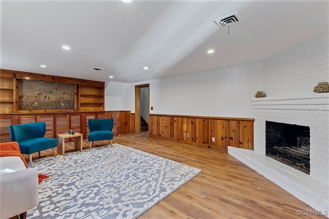 sitting room with a fireplace and light hardwood / wood-style floors