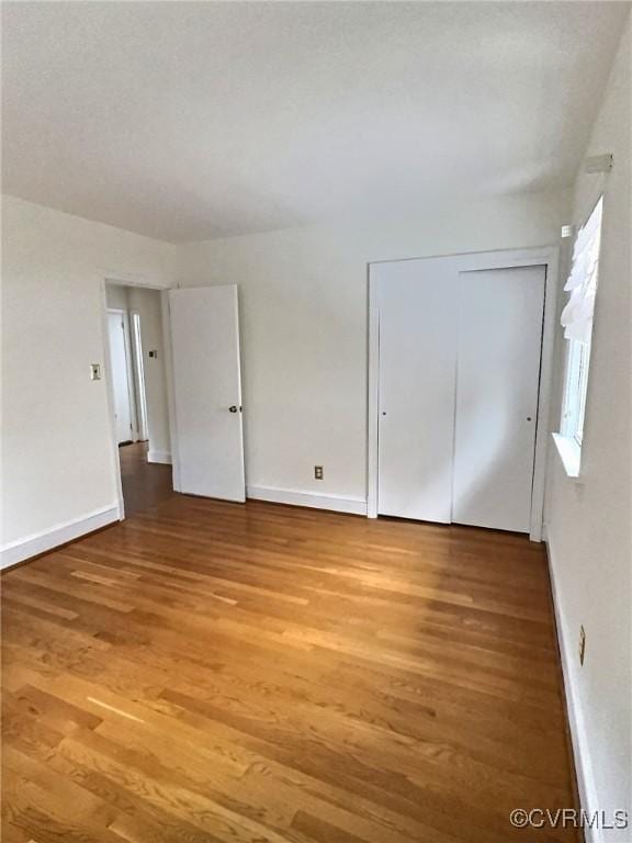 spare room featuring wood-type flooring