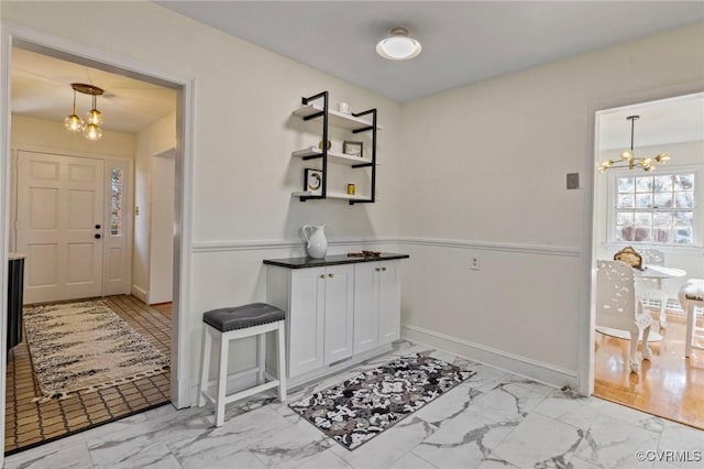 foyer with an inviting chandelier