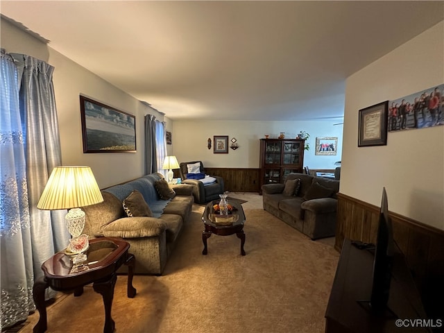 carpeted living room with wood walls