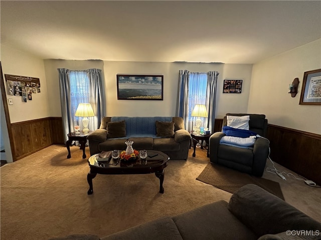 carpeted living room featuring wood walls