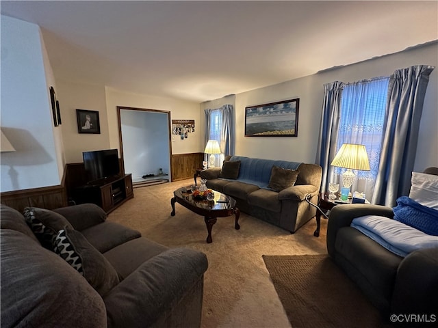 living room featuring wood walls and light carpet