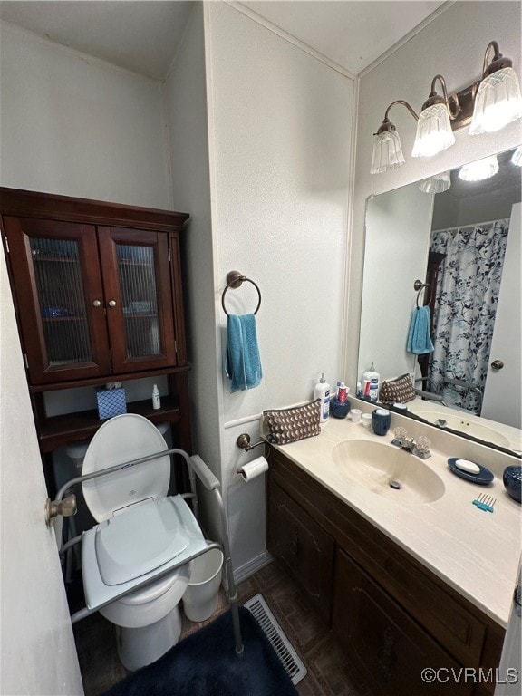 bathroom featuring toilet and vanity