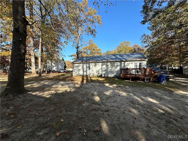 rear view of house featuring a wooden deck