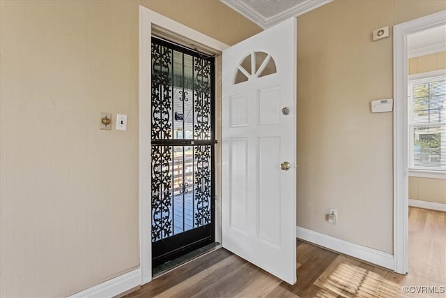 foyer entrance featuring dark hardwood / wood-style flooring and crown molding