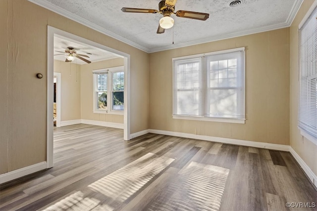 empty room with crown molding, light hardwood / wood-style flooring, and a healthy amount of sunlight