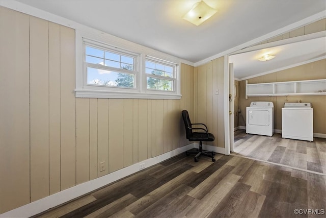 interior space with washer and clothes dryer, wood-type flooring, wooden walls, and vaulted ceiling