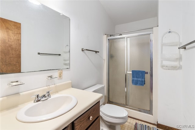 bathroom with a shower with door, vanity, and toilet