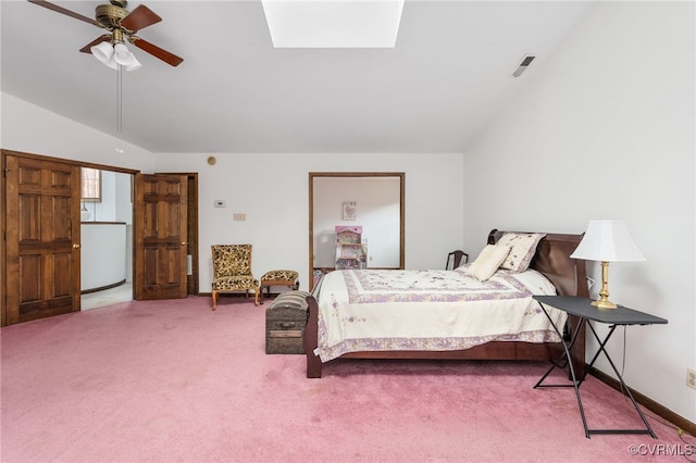 carpeted bedroom with lofted ceiling with skylight and ceiling fan