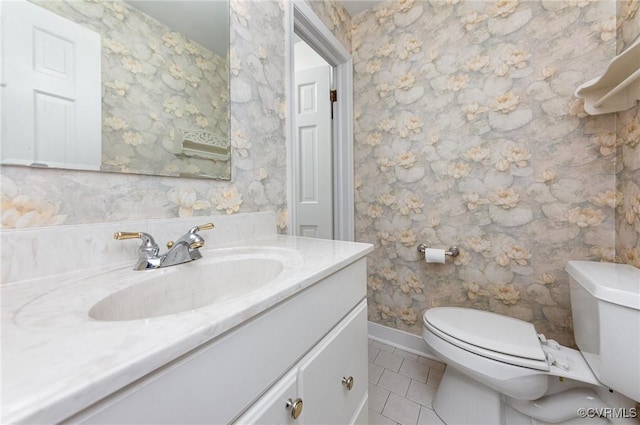 bathroom featuring vanity, tile patterned floors, and toilet