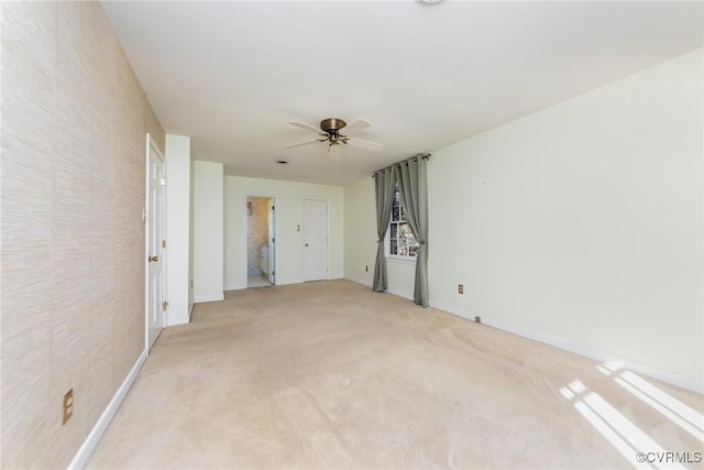 spare room with light colored carpet and ceiling fan