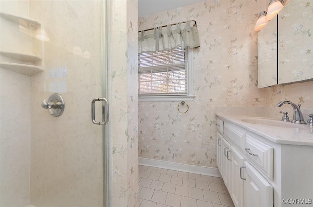 bathroom with vanity, a shower with shower door, and tile patterned floors