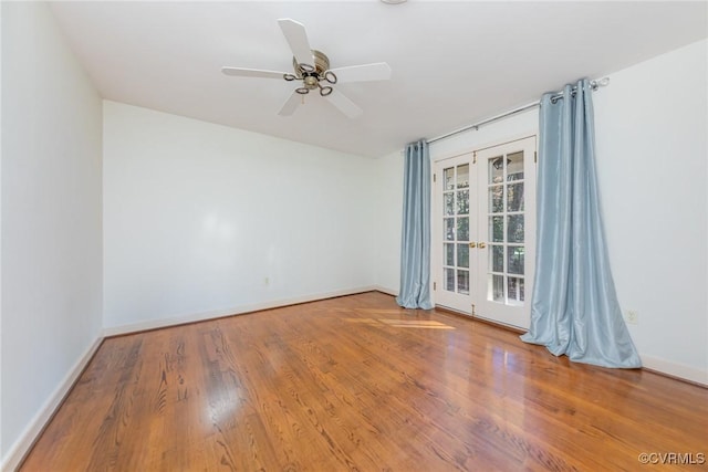 spare room with hardwood / wood-style flooring, ceiling fan, and french doors