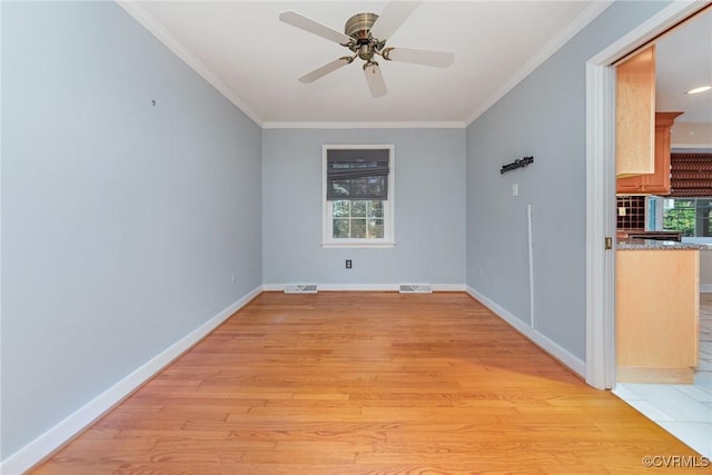 spare room featuring crown molding, light hardwood / wood-style flooring, and ceiling fan