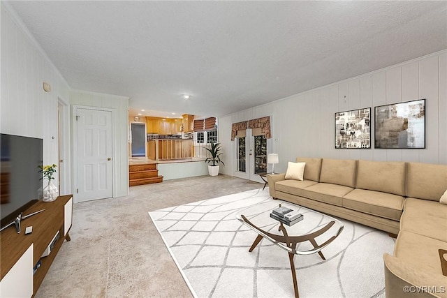 carpeted living room featuring a textured ceiling