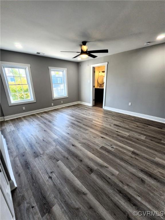 spare room featuring ceiling fan and dark hardwood / wood-style flooring