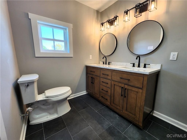 bathroom featuring toilet, vanity, and tile patterned floors