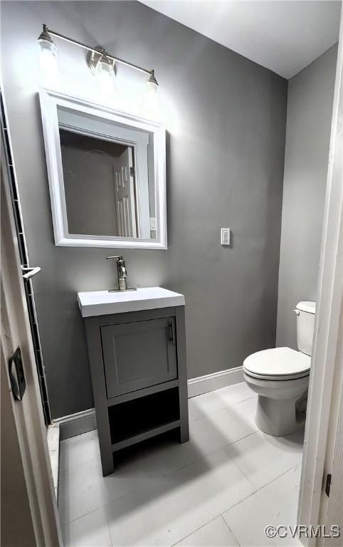 bathroom with tile patterned floors, vanity, and toilet