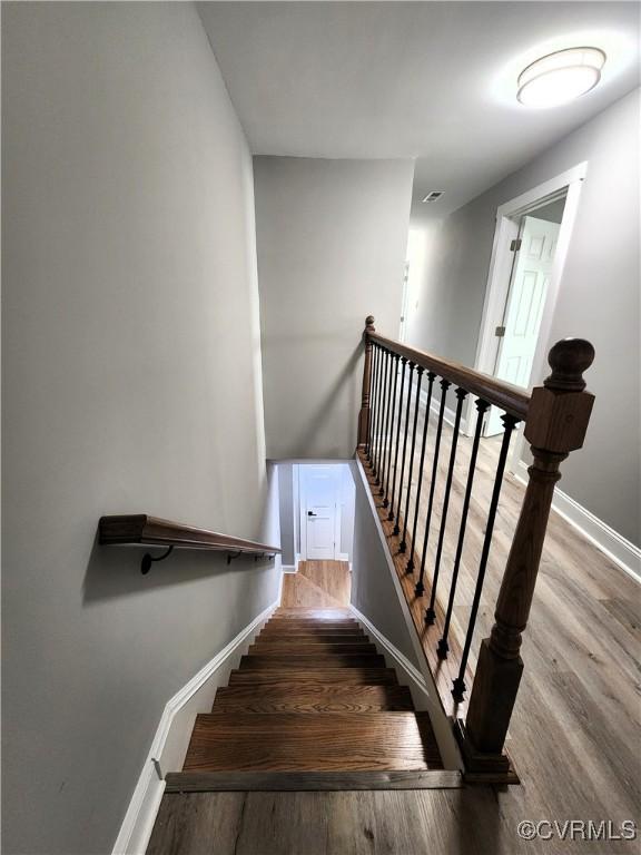 stairs with hardwood / wood-style flooring