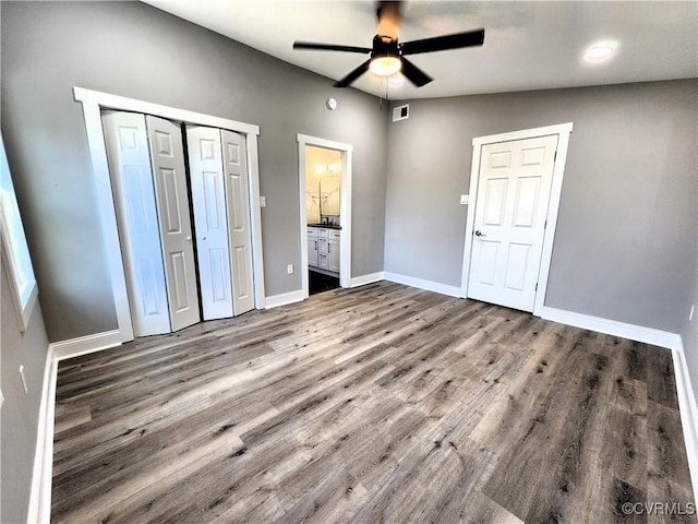 unfurnished bedroom featuring ceiling fan, wood-type flooring, and lofted ceiling