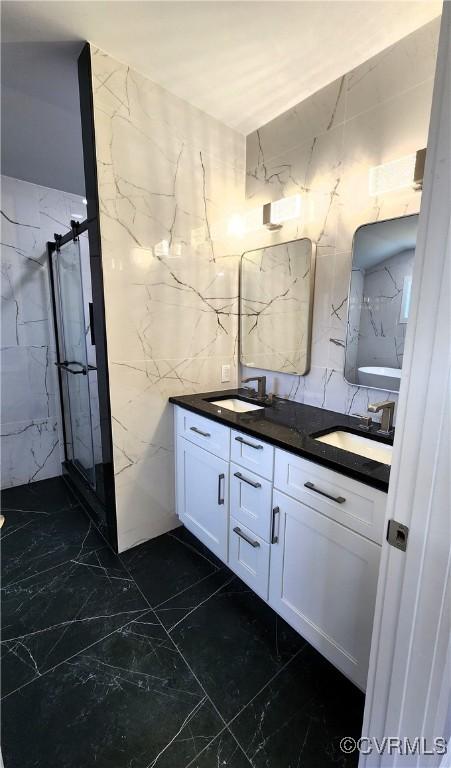 bathroom featuring vanity, tile walls, and walk in shower