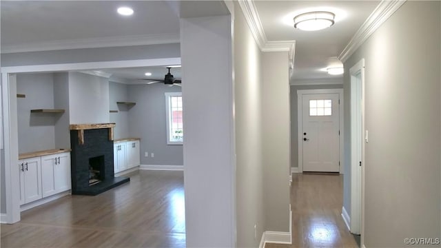 corridor featuring crown molding and light hardwood / wood-style flooring