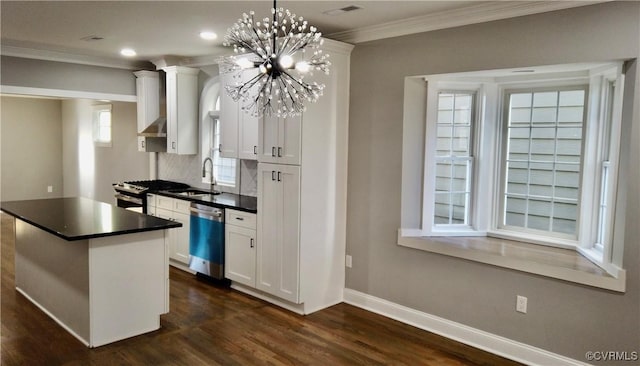 kitchen with an inviting chandelier, white cabinets, sink, decorative light fixtures, and stainless steel appliances