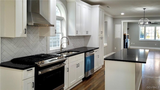 kitchen with a center island, sink, stainless steel appliances, wall chimney range hood, and white cabinets