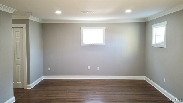 empty room featuring ornamental molding and dark wood-type flooring