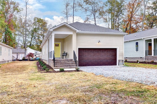 view of front of home with a garage and a front lawn