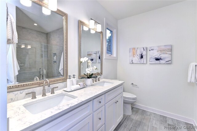 3557 Odi St, West Point, VA 23181 - full bath with double vanity, a stall shower, and wood finished floors