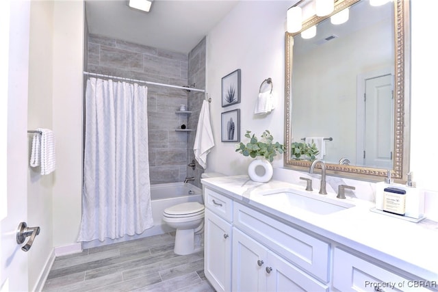 full bathroom with vanity, wood-type flooring, shower / tub combo, and toilet