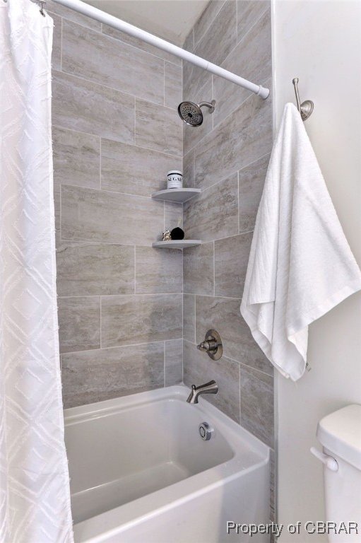 bathroom with toilet and shower / bathtub combination with curtain