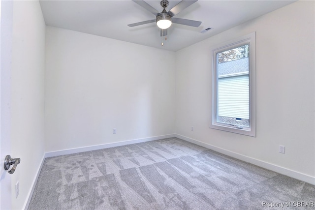 unfurnished room with ceiling fan and light colored carpet