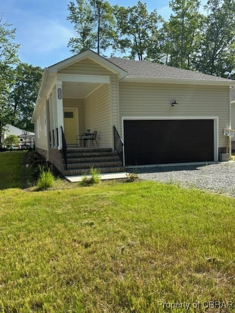 3557 Odi St, West Point, VA 23181 - view of front of property featuring a garage, a porch, a front yard, and driveway